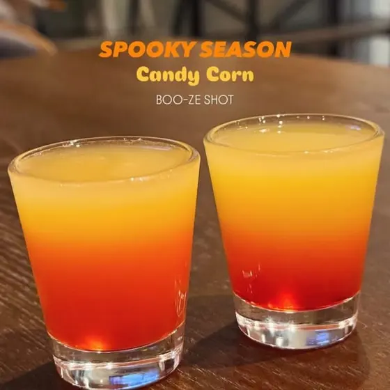 Two candy-corn colored “boo-ze” shots for spooky season.